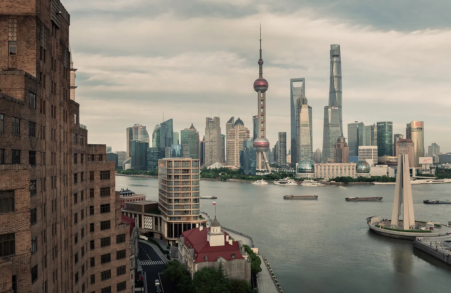A panoramic view of a modern cityscape featuring contemporary skyscrapers and riverfront architecture.