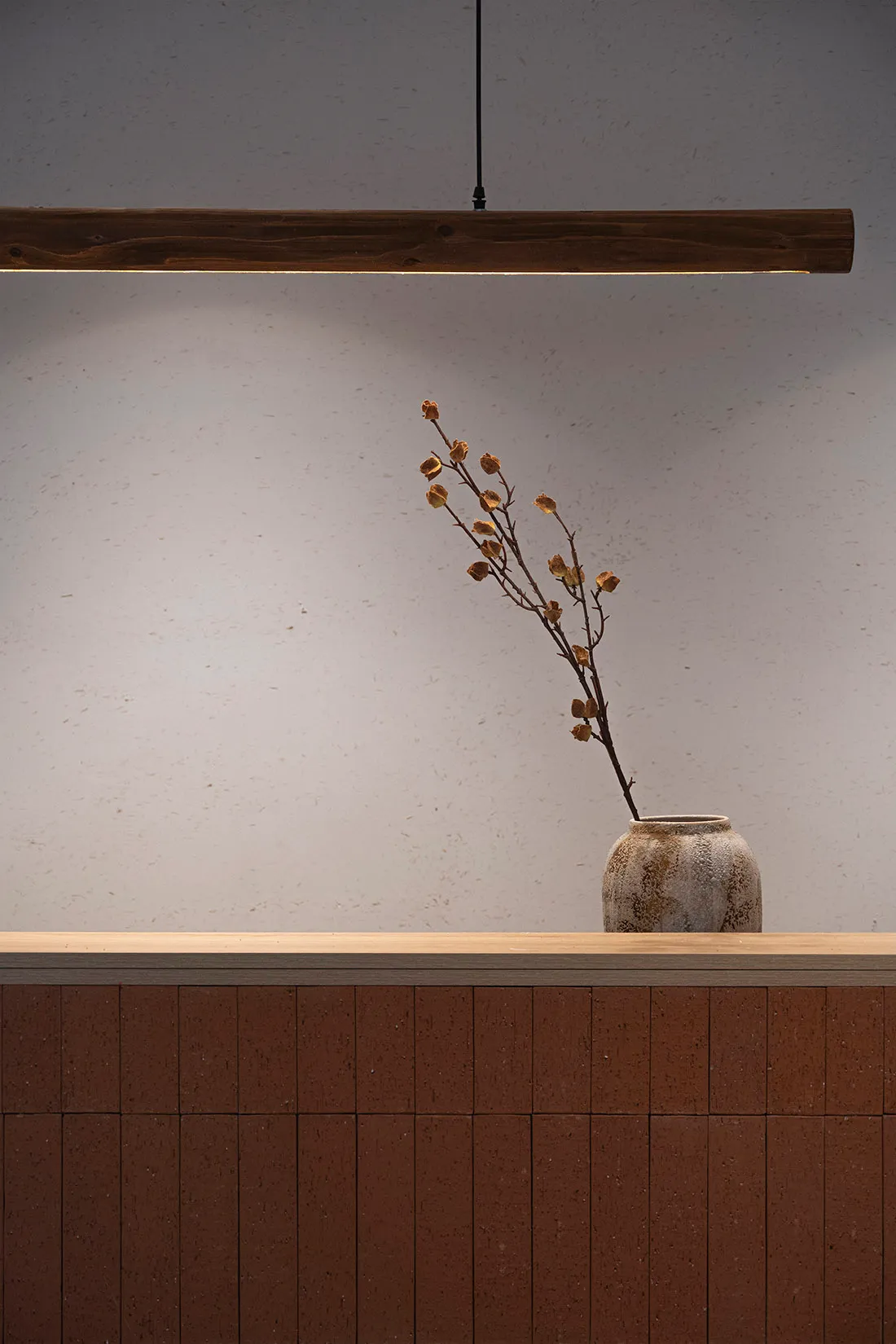 Decorative arrangement featuring dried flowers in a minimalist setting with terracotta elements.