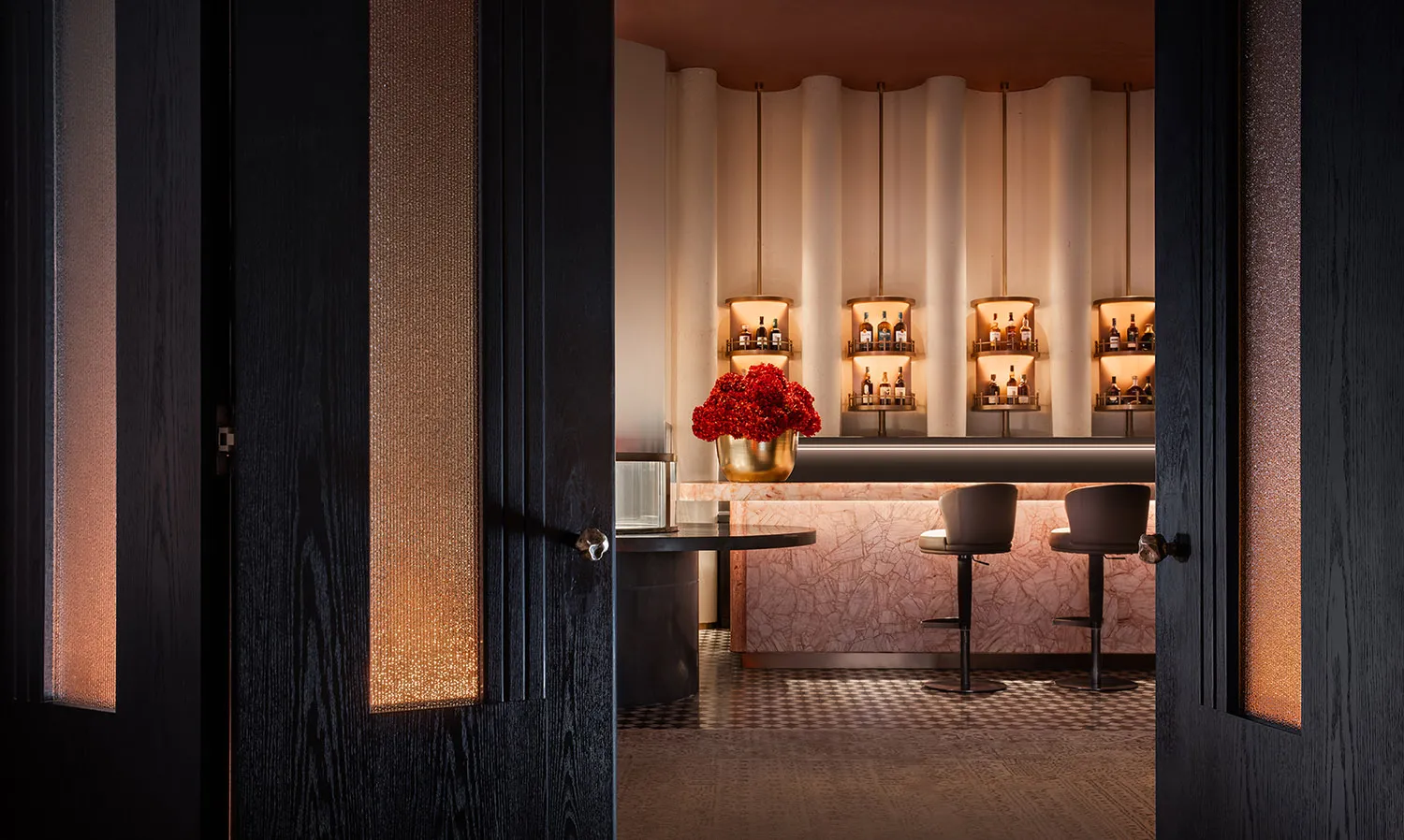 A modern bar interior with marble accents and a minimalist design.