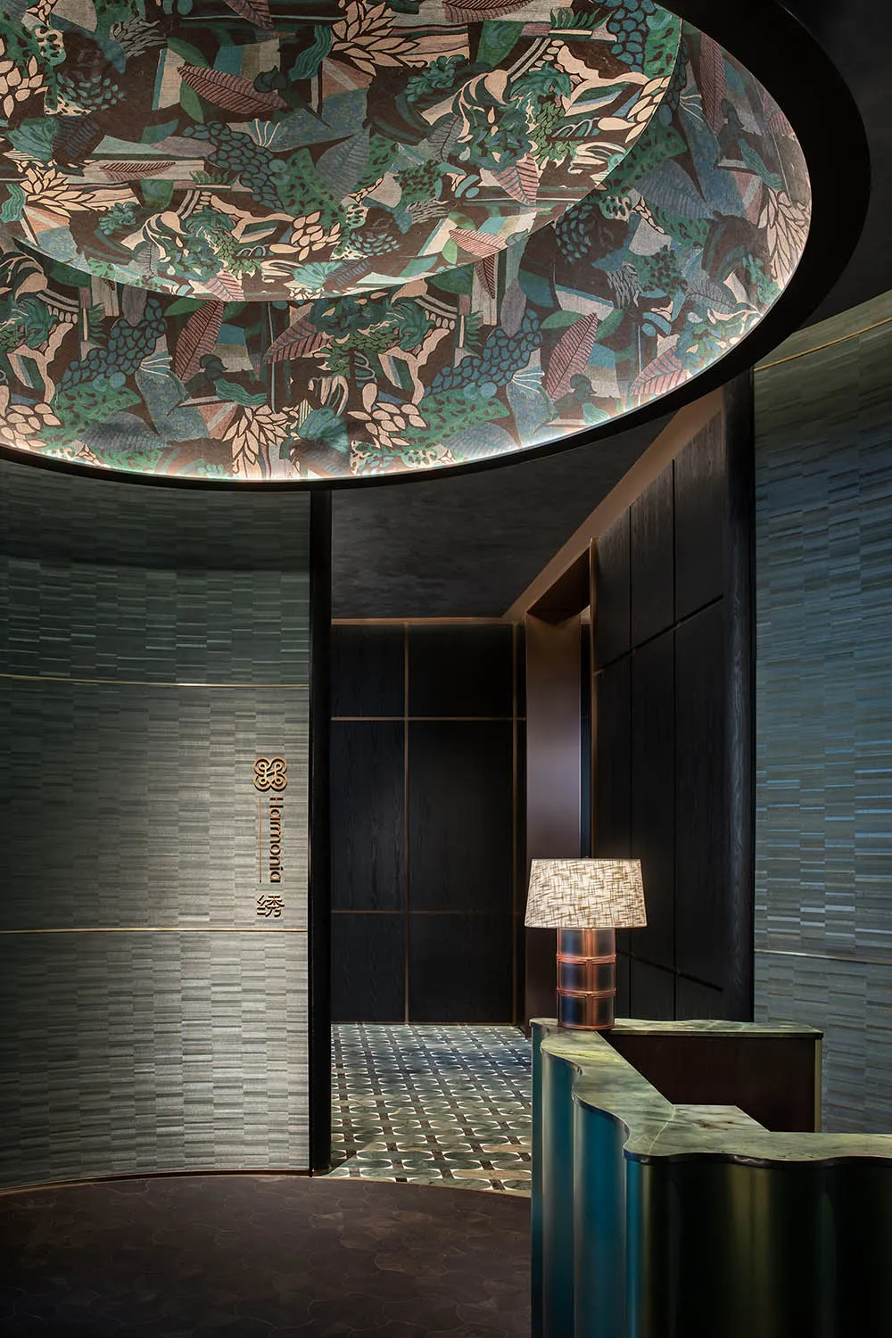 A contemporary lobby with a visually striking ceiling design, featuring a mix of materials and dark wood finishes.
