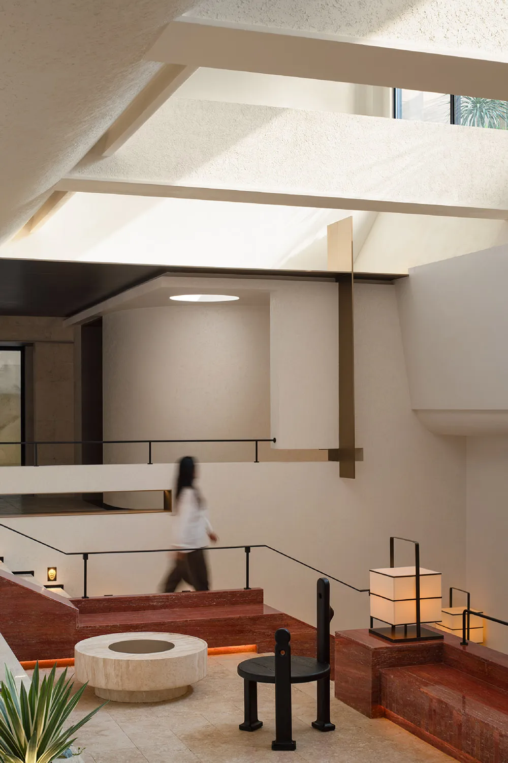 Modern home interior featuring concrete walls, marble accents, and brass fixtures.