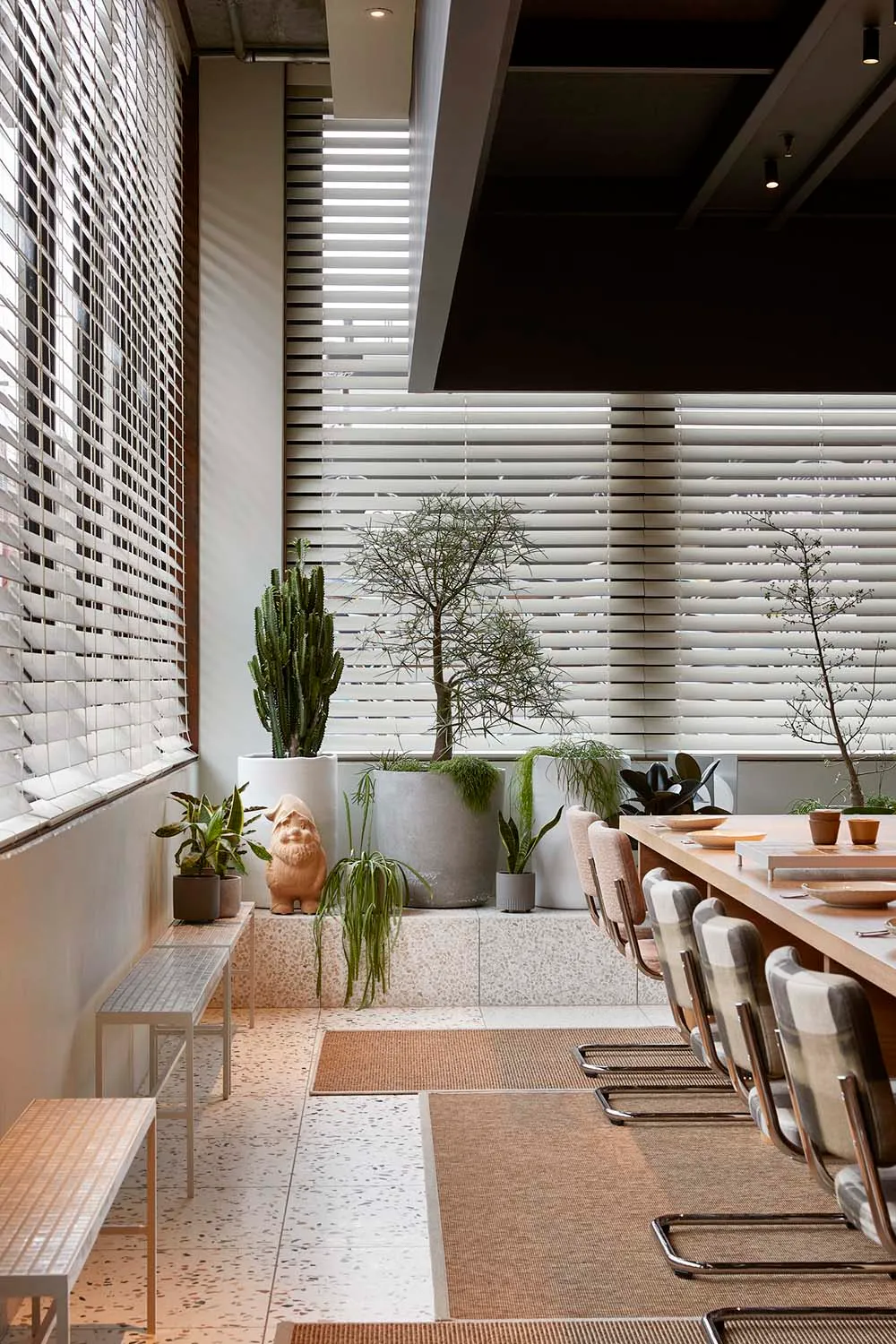 A contemporary commercial interior featuring industrial design elements such as concrete, glass, and wood materials.