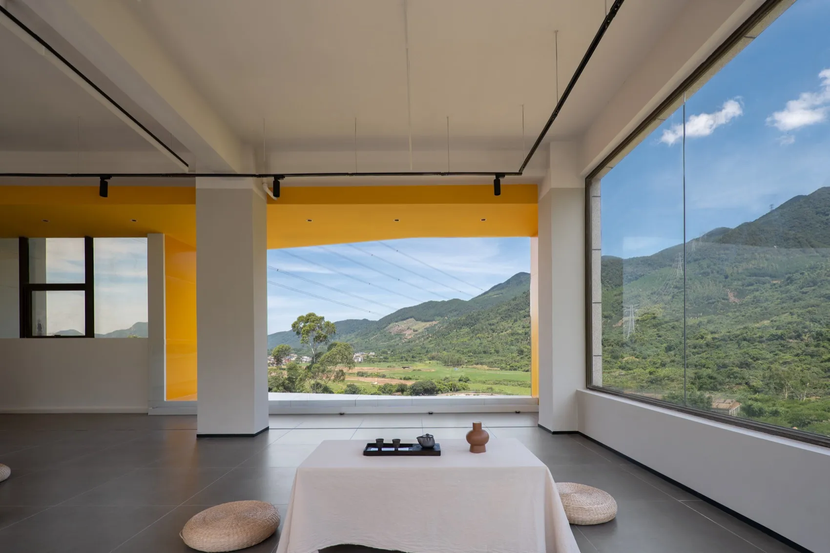 Photograph of a modern residential interior with concrete flooring and walls.