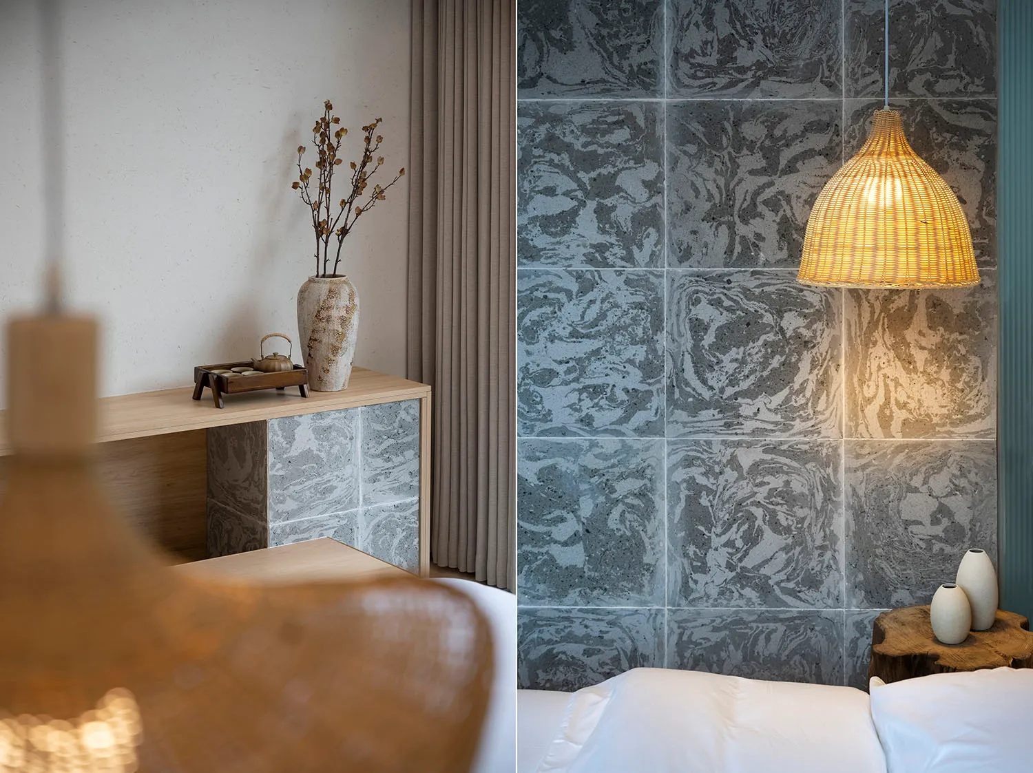 A modern bedroom featuring concrete tiles, white bedding, and a wooden table with decorative vases and a small kettle.