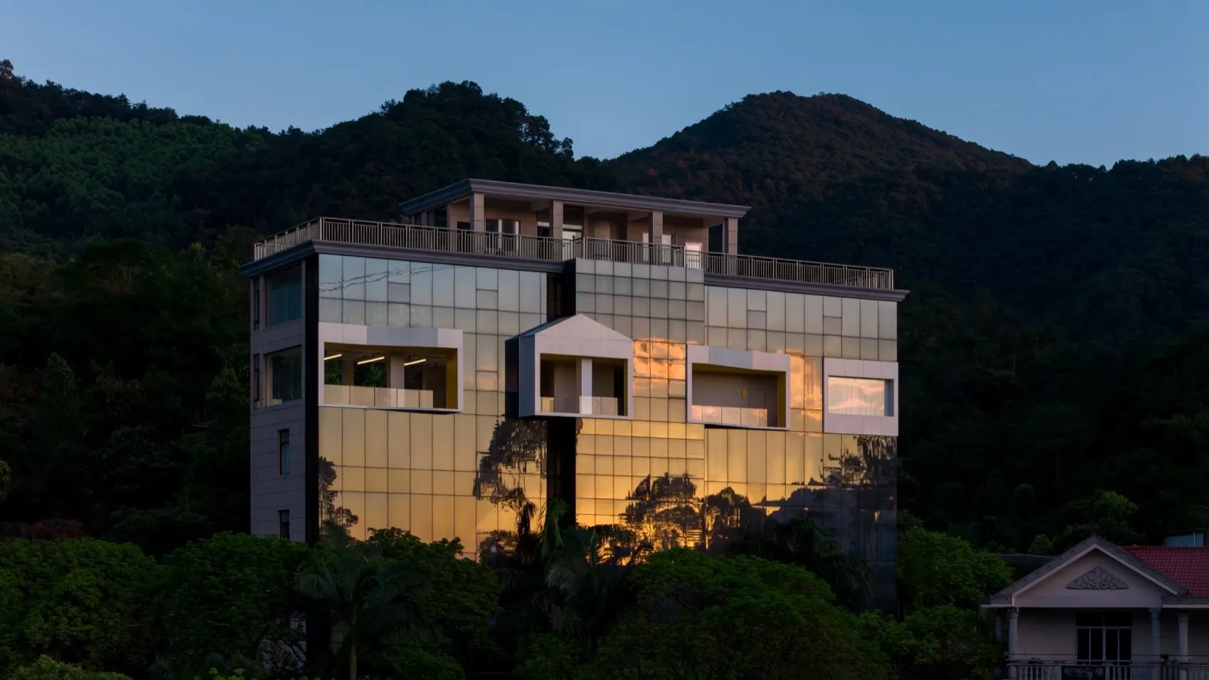 Modern residential building exterior with glass facade