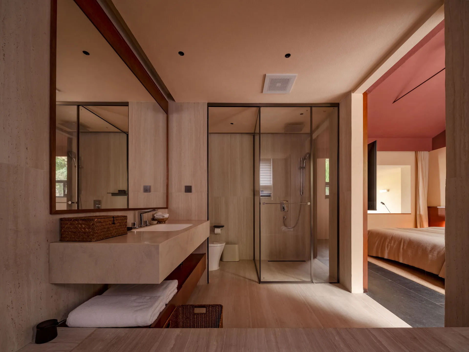 A modern bathroom featuring minimalist design with tile walls and floor.