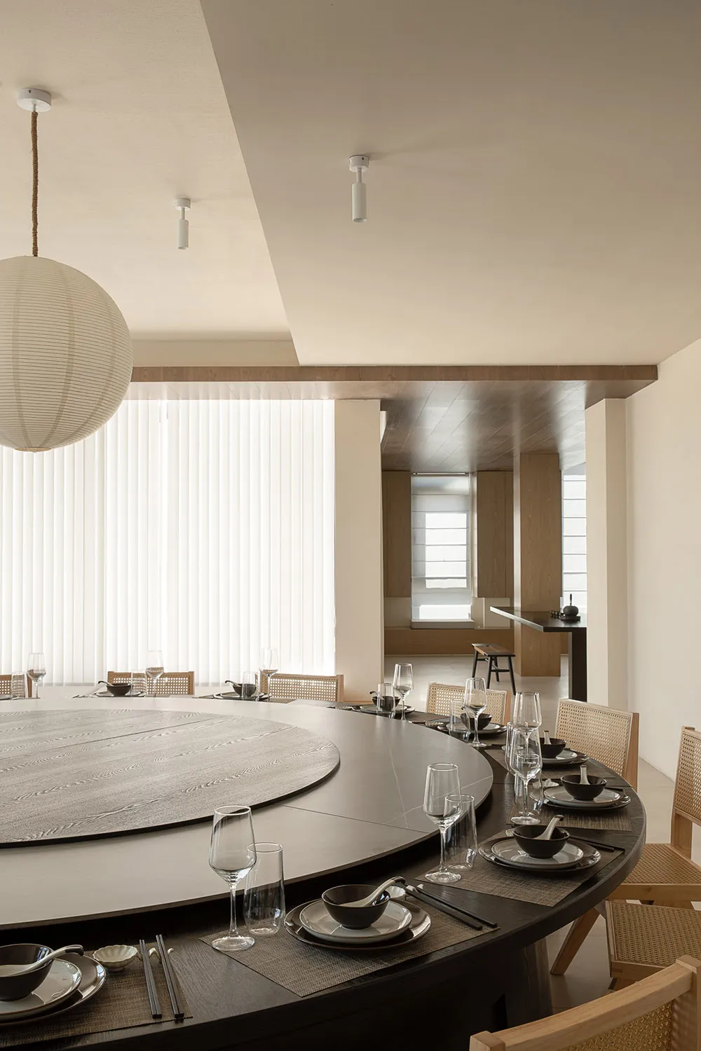 A modern dining room with a circular table, designed for comfortable seating and conversation.