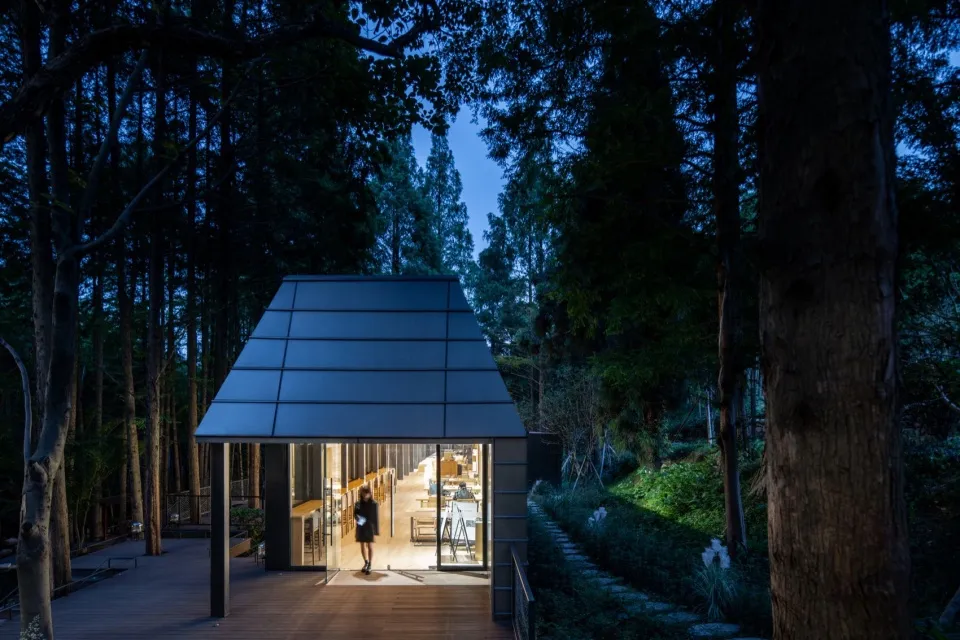 Modern hotel walkway illuminated with glass doors and metal frame