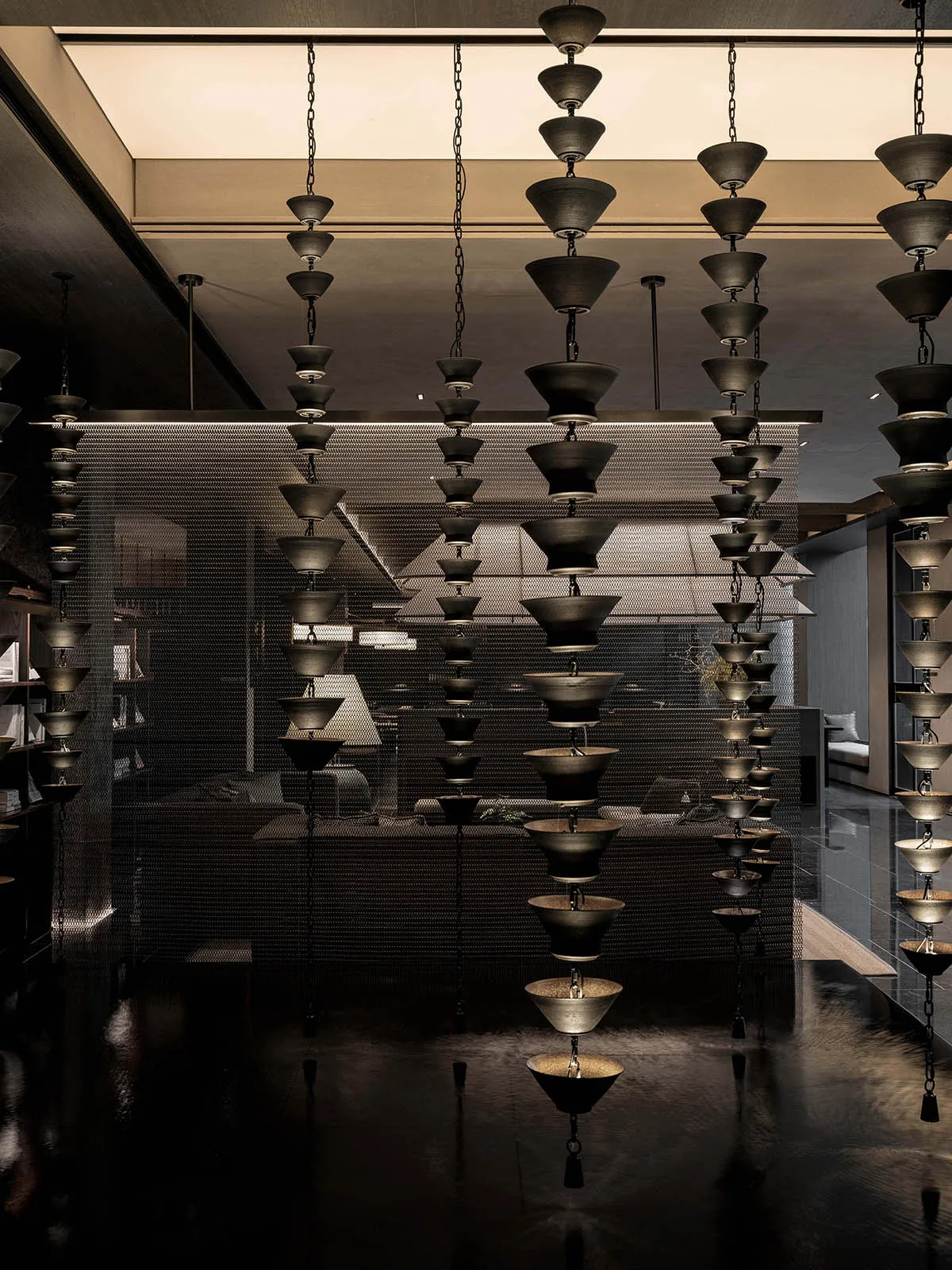 An industrial-style hanging lighting system composed of multiple metal components.