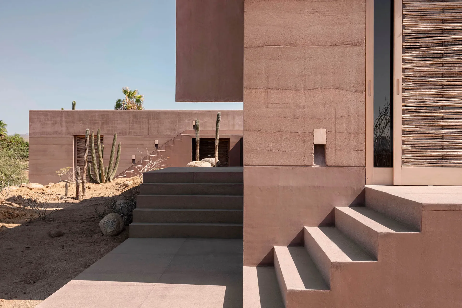Minimalist exterior architecture featuring desert stonework.