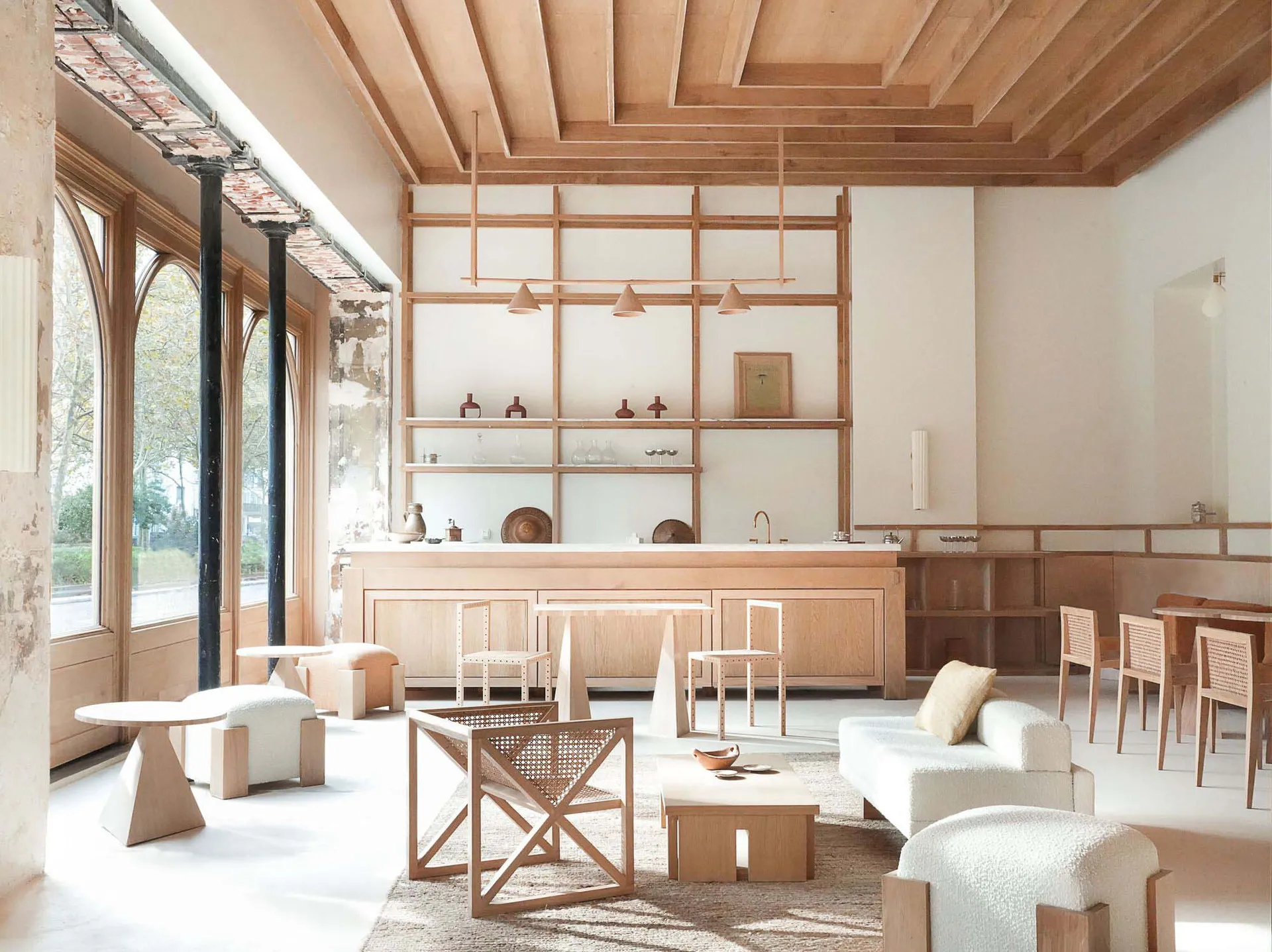 A modern minimalist cafe bar with wooden interiors and bar counter.