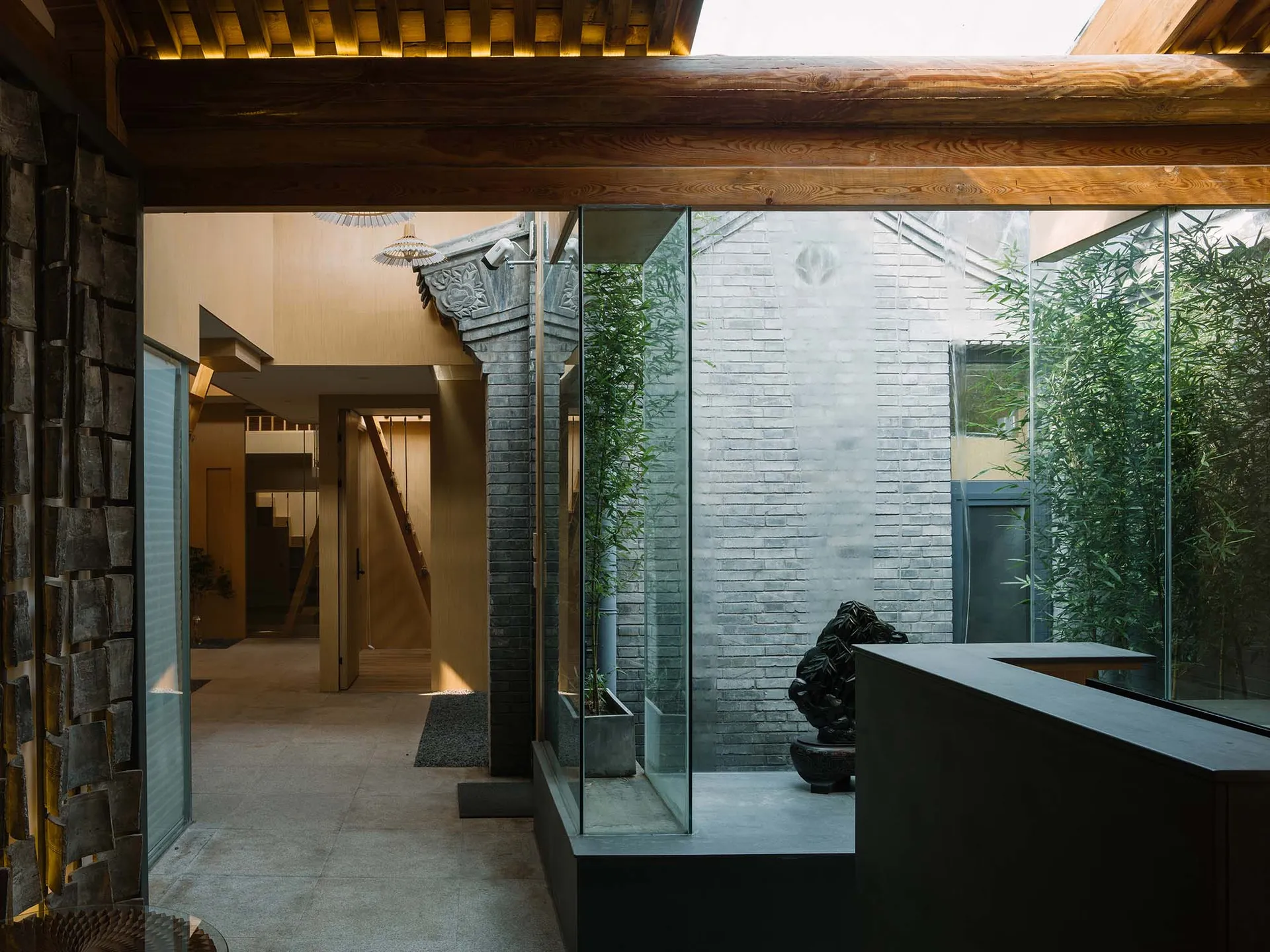 A modern minimalist lobby with transparent glass walls and minimalist design elements.