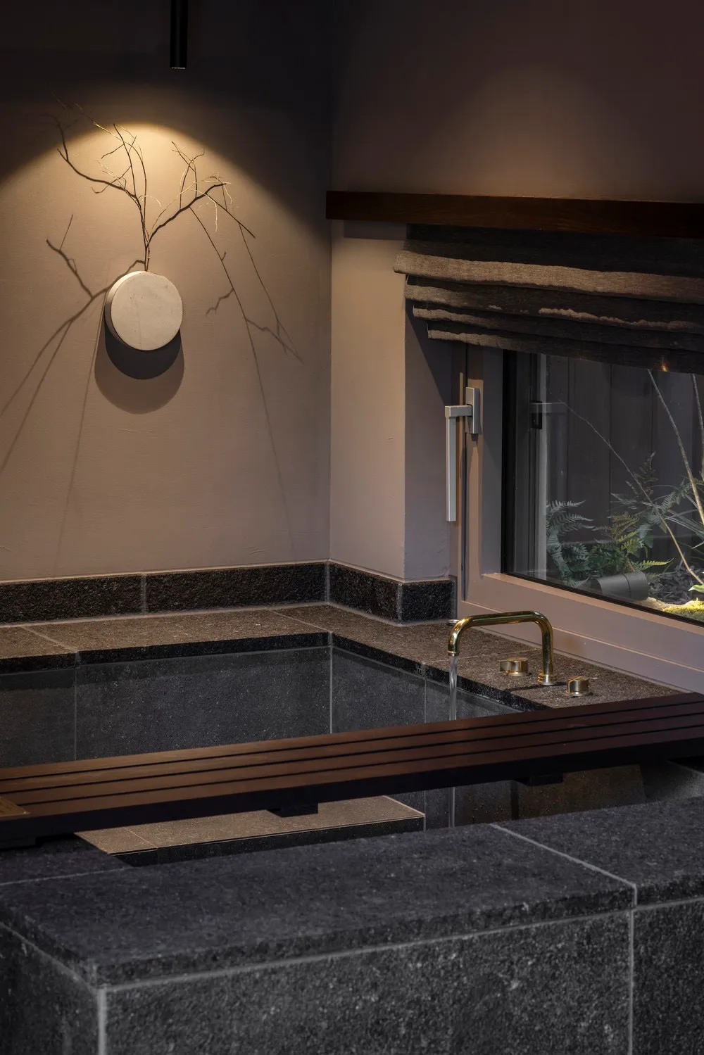 Modern stone bathroom with minimalist design and natural light.