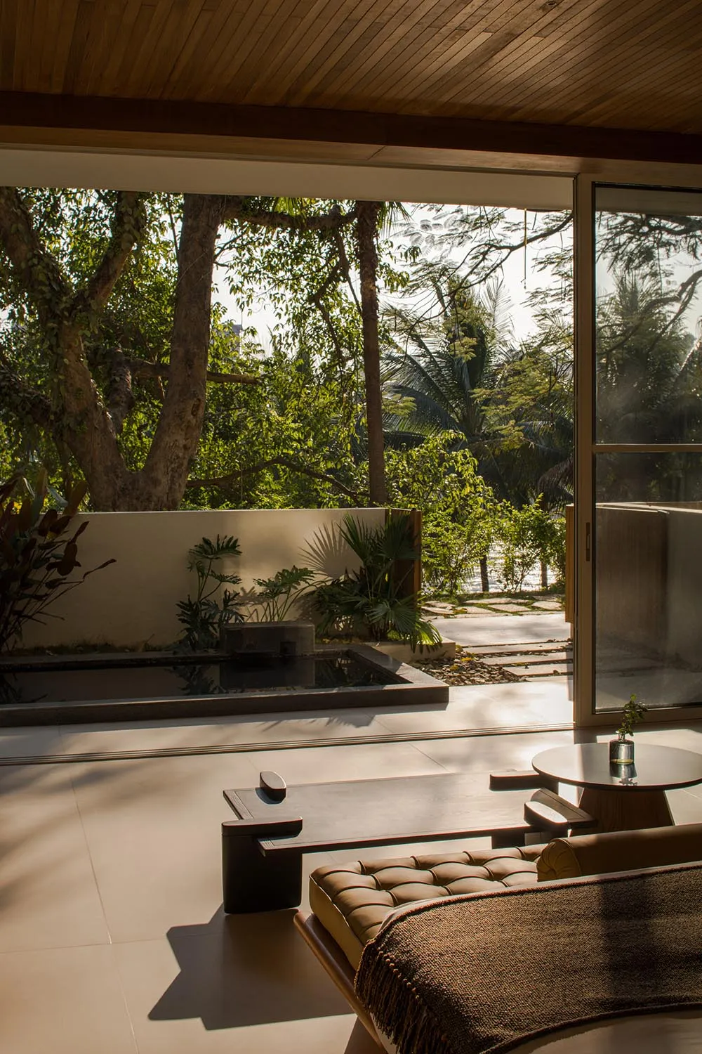 A modern interior design contemporary living room with wooden elements, a view of nature, and minimalist furniture.