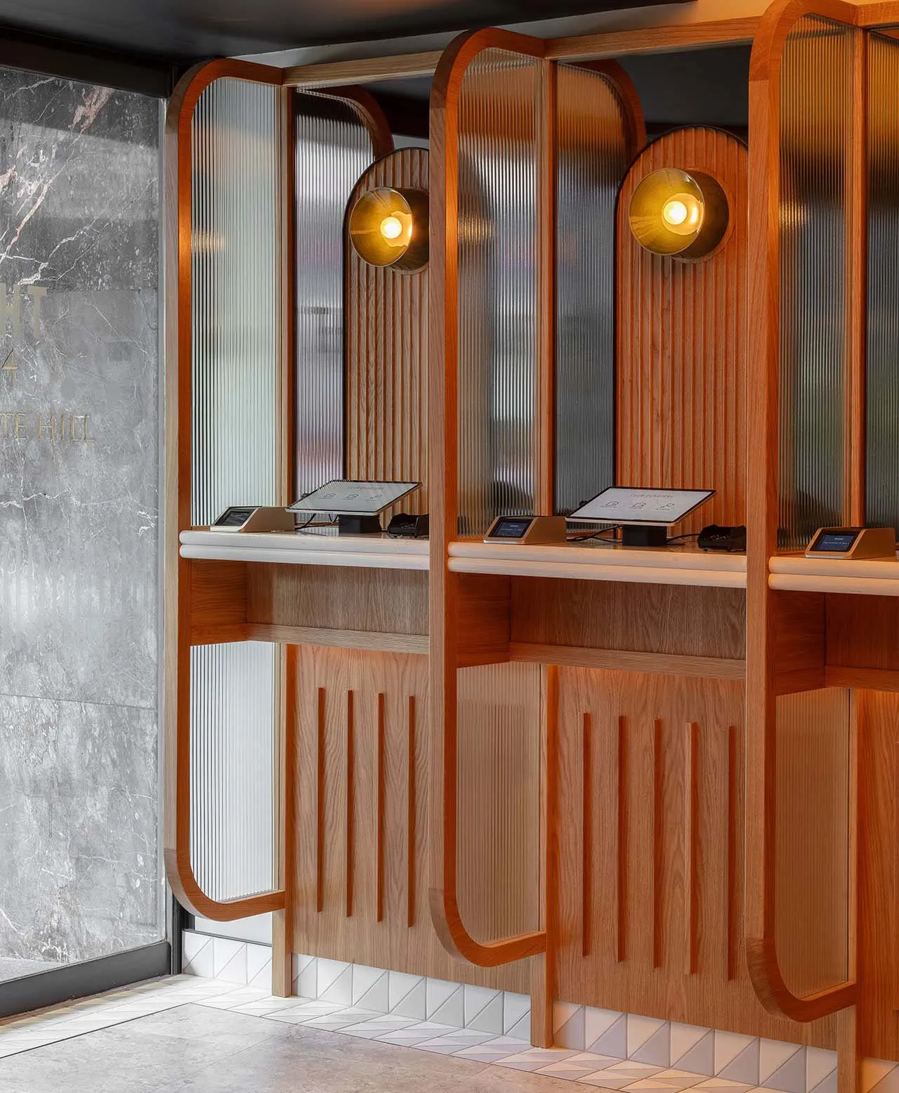 Modern restaurant interior featuring transparent glass walls and wooden fixtures.