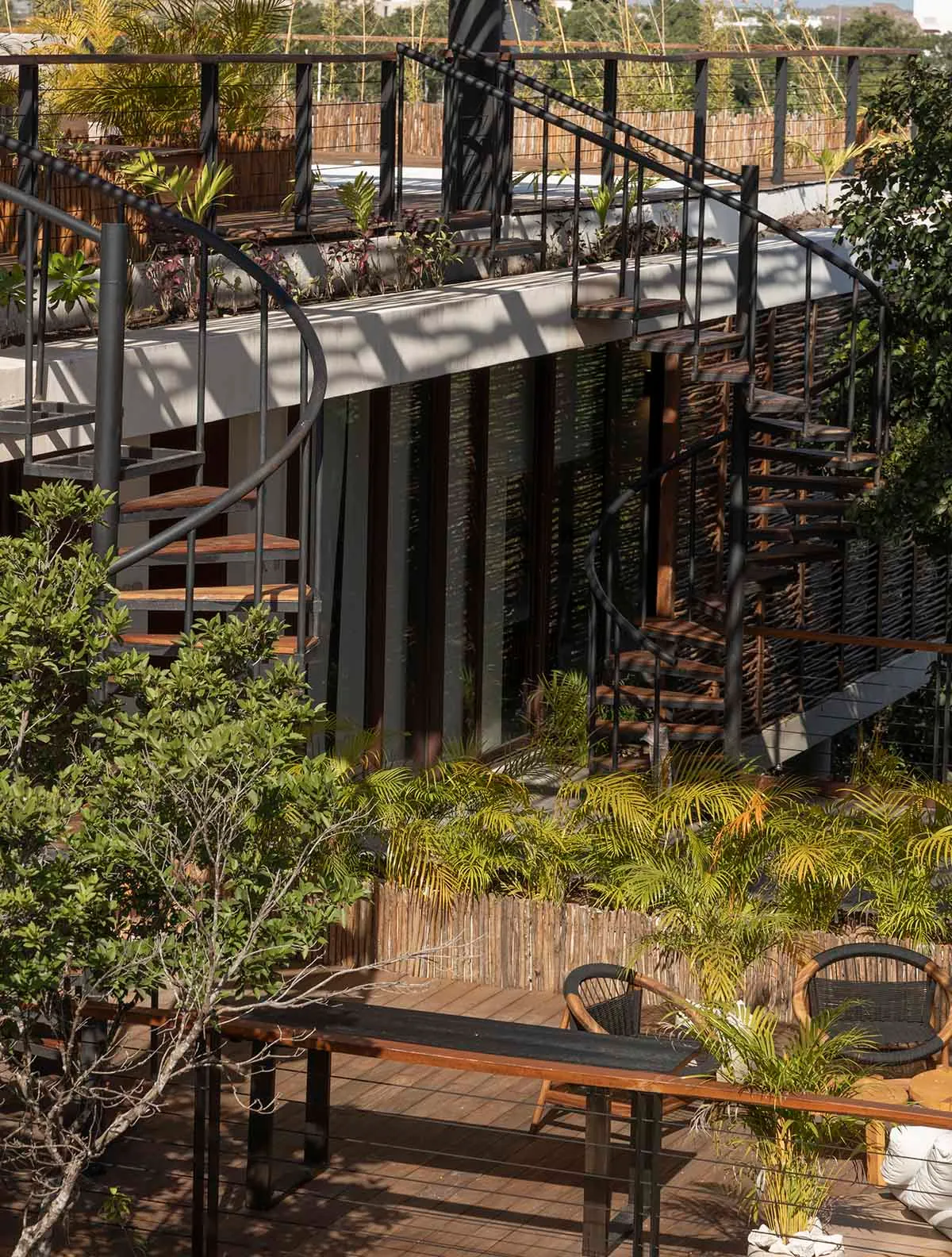 Modern building exterior featuring wood, metal, and lush greenery