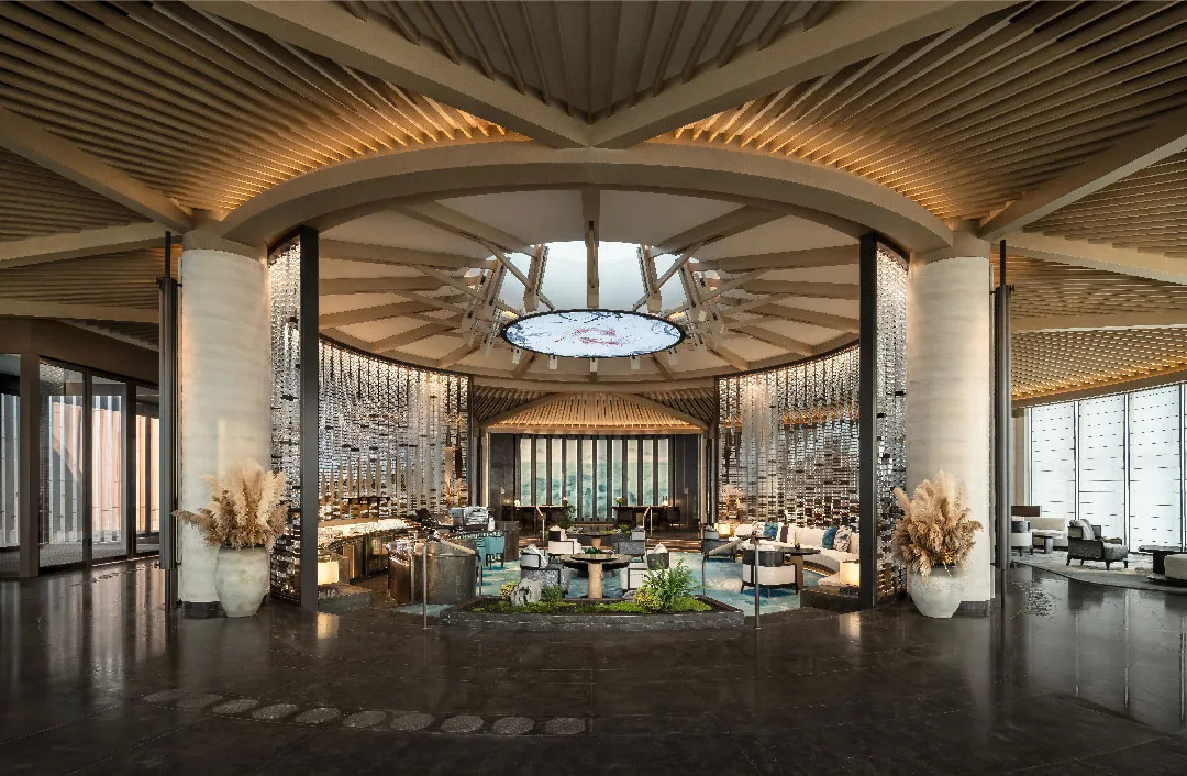 A modern hotel lobby featuring glass and concrete materials