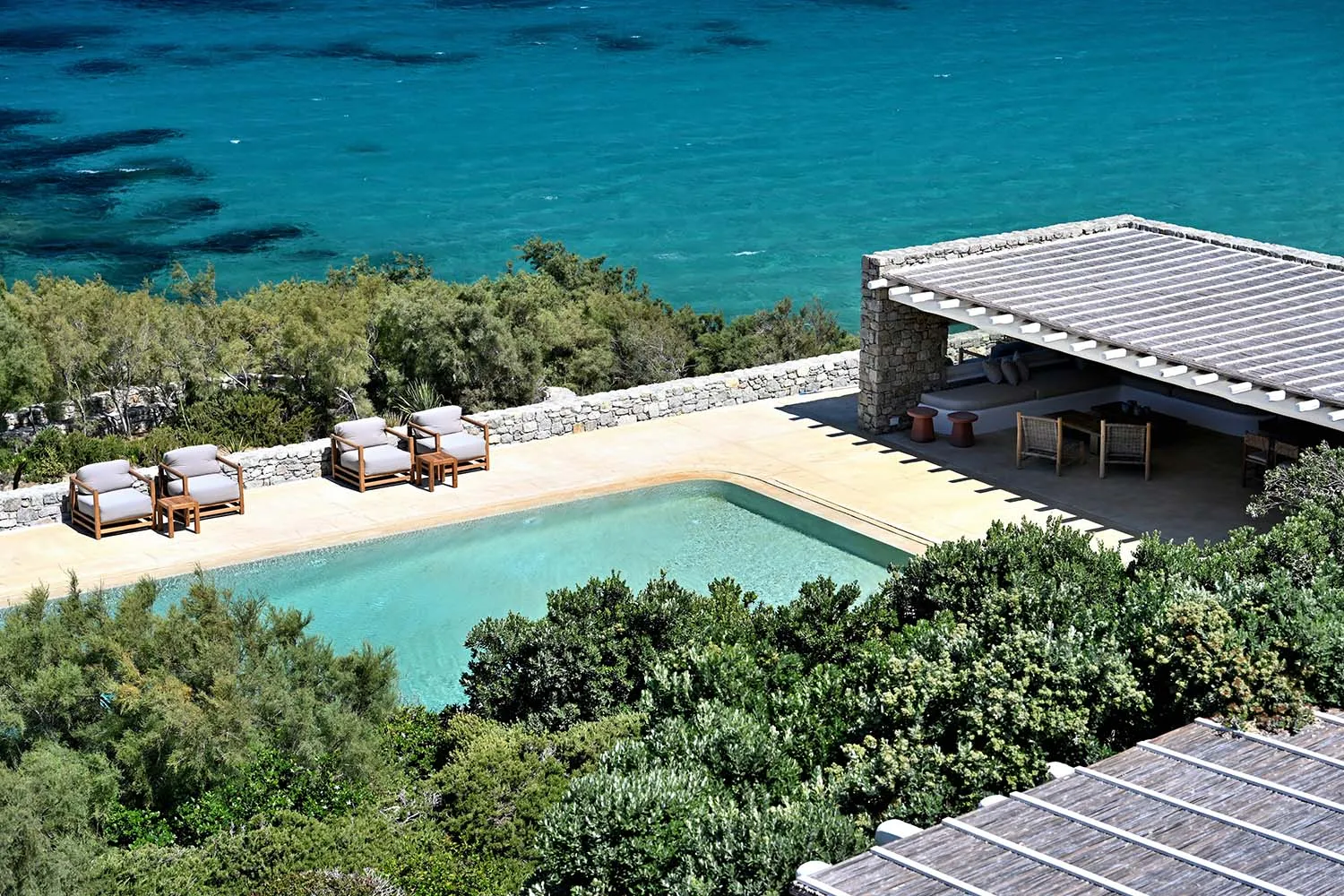 Terracotta roof tiles and lounge area near a poolside.