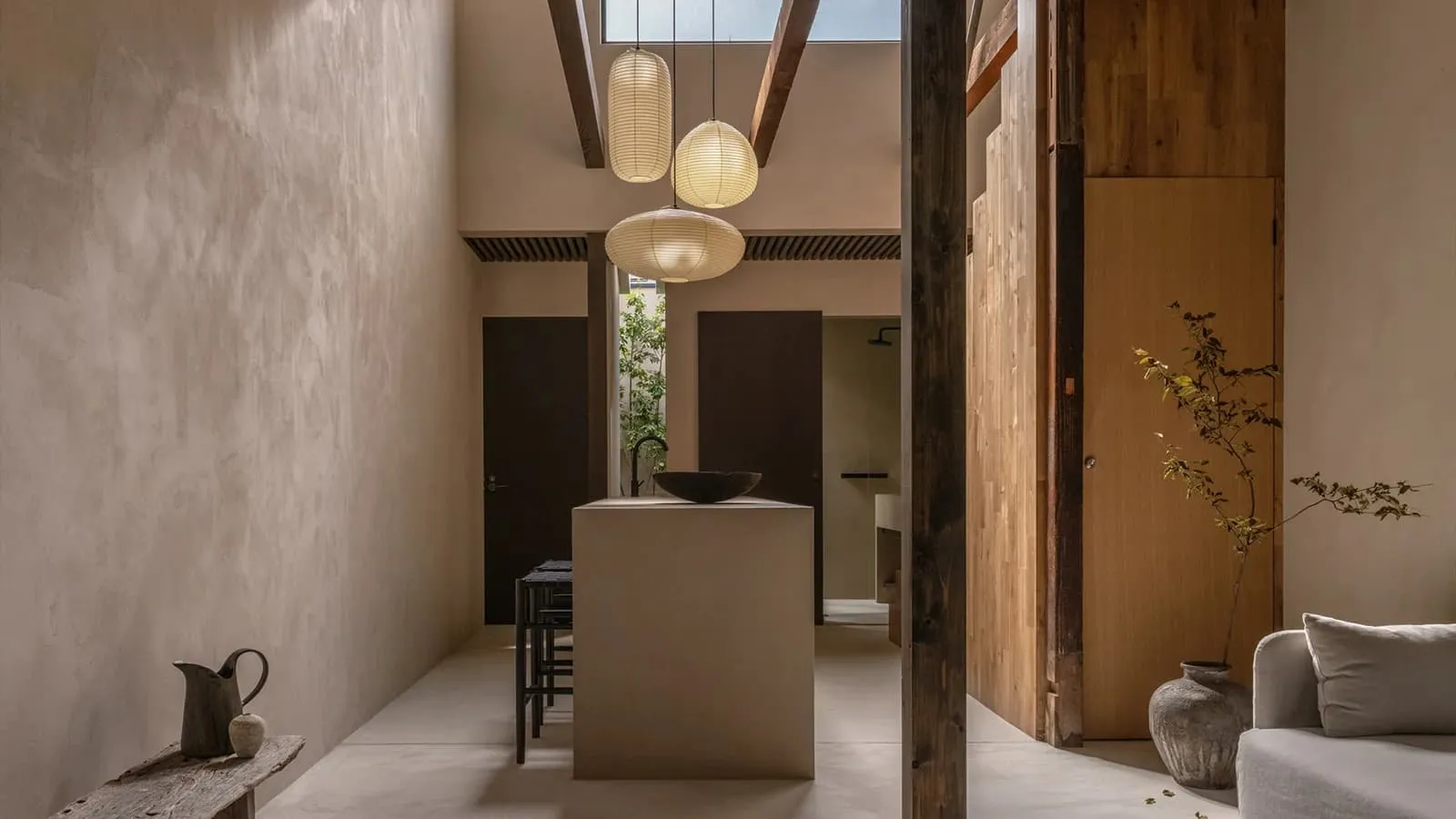 A modern residential interior featuring concrete walls and wooden elements.