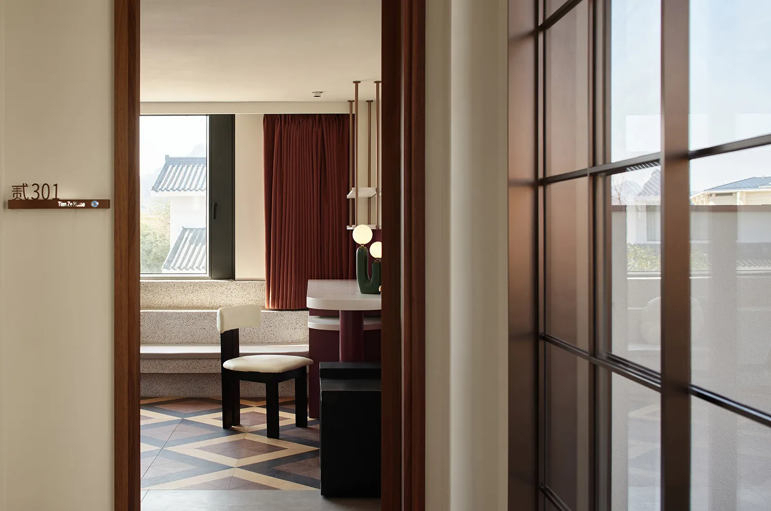 A modern residential room with wooden furniture, ceramic floor tiles, and minimalist decor.