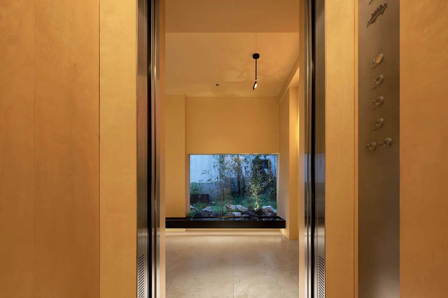 An open-plan industrial-style lobby with concrete walls and floor, featuring a minimalist design.