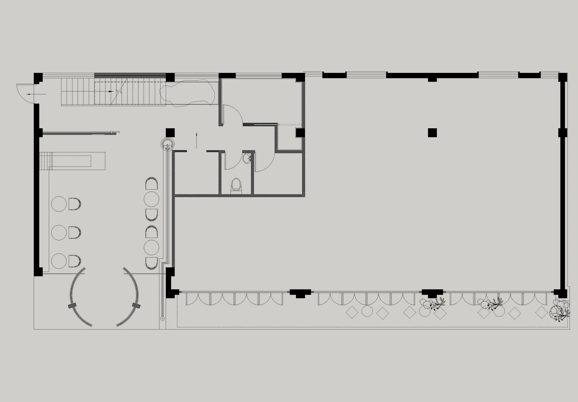Floor plan of an office space with windows, desks, and a staircase.