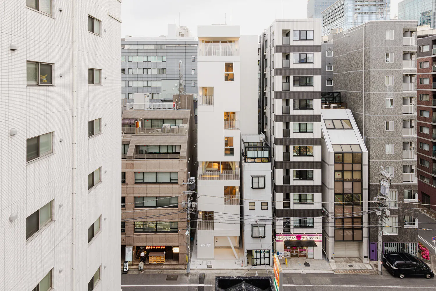 A modern cityscape featuring buildings constructed from concrete, glass, and metal.