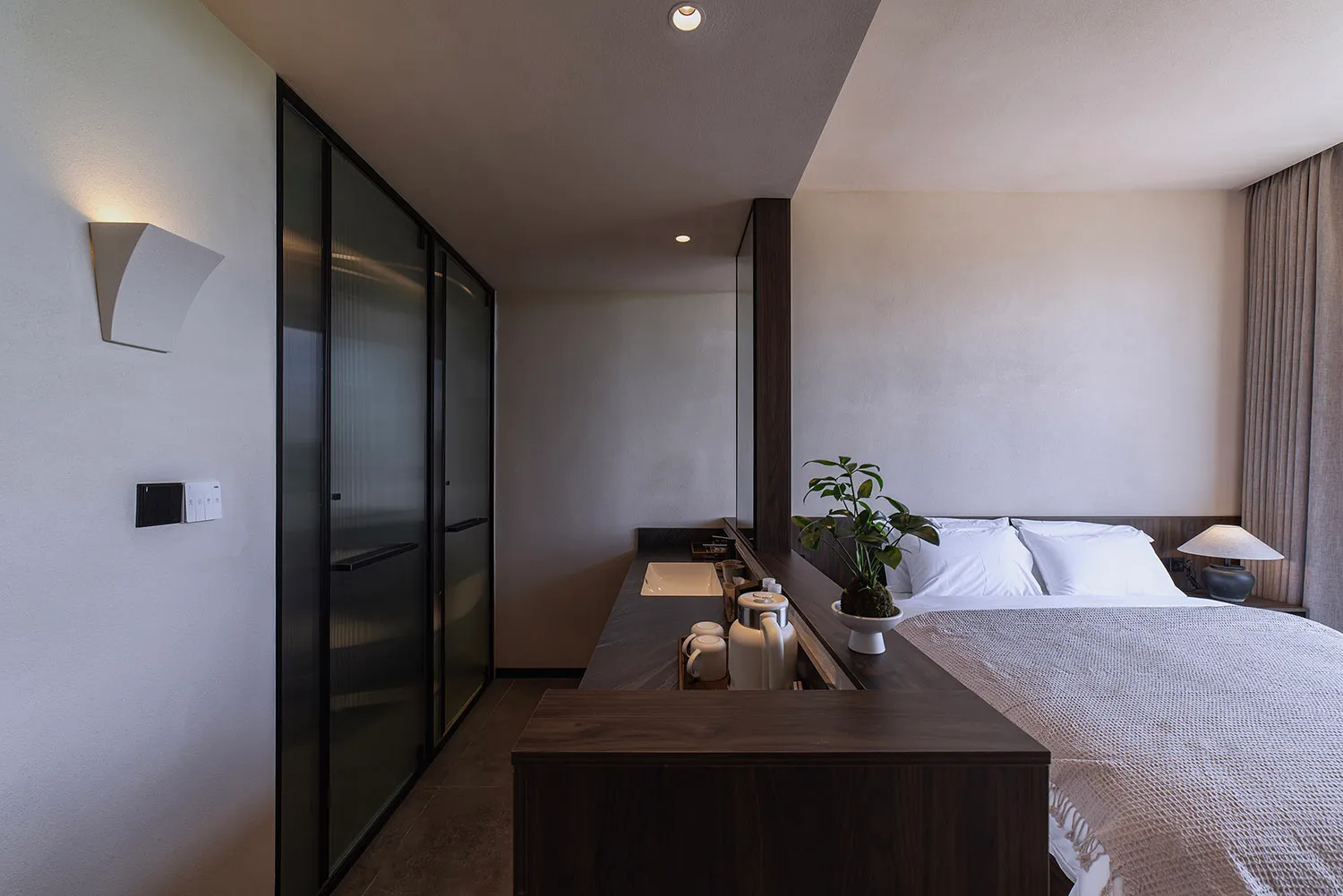 A modern bedroom with wooden furniture and minimalist design.