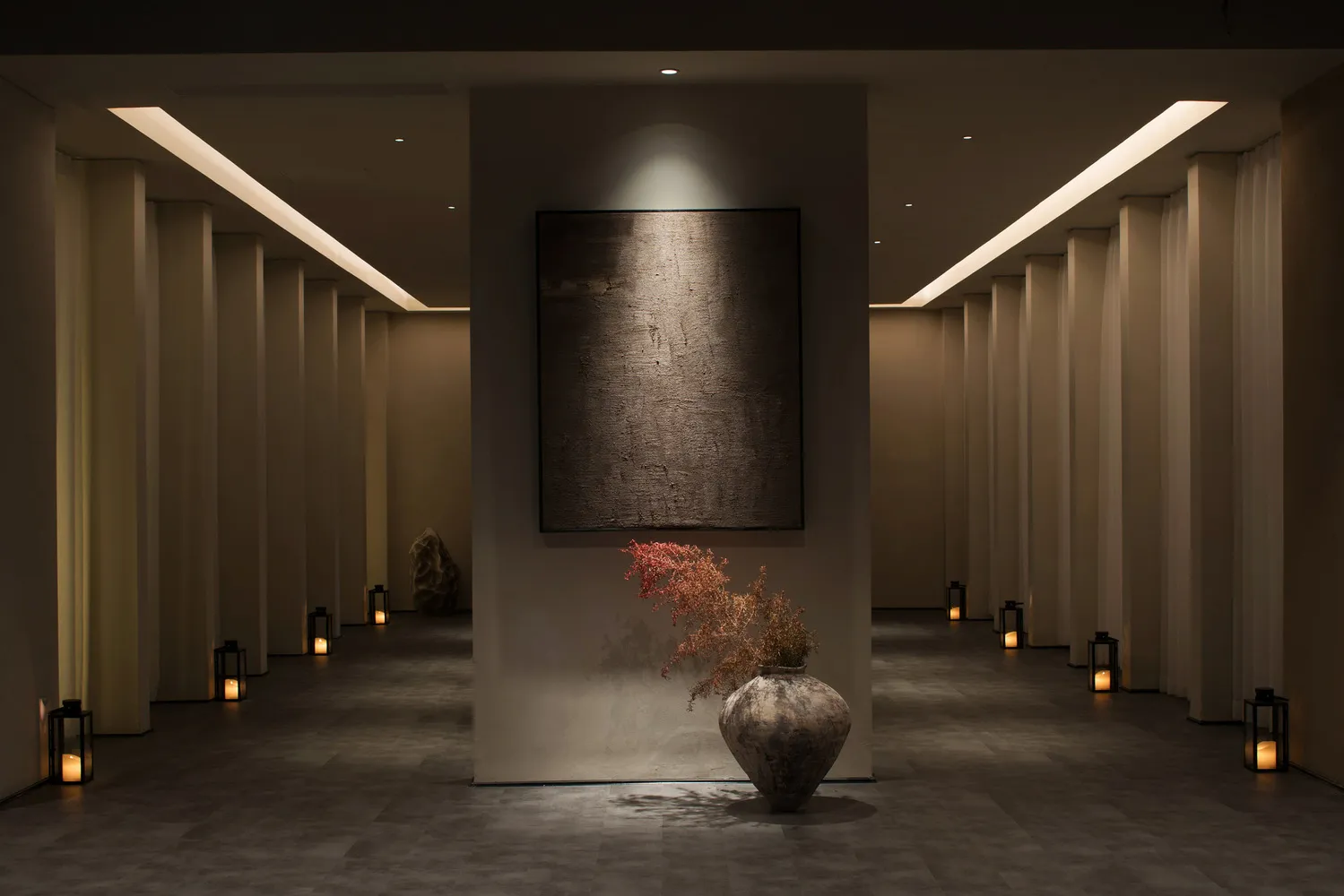 A minimalist spa interior featuring metal cladding walls and a minimalist artwork.