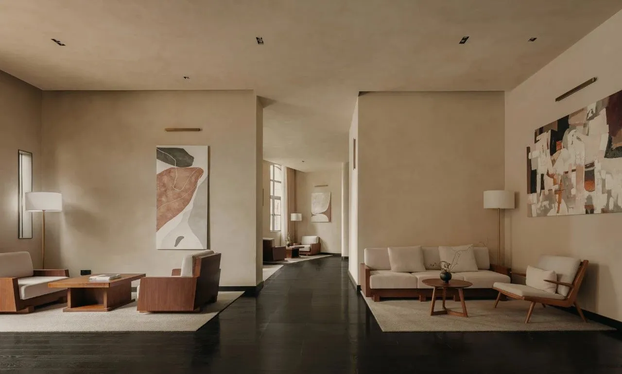 A modern living room with neutral tones, featuring minimalist furniture and abstract art.