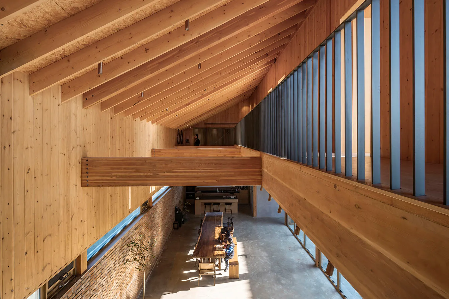 Industrial-style modern office space featuring exposed wooden beams and natural light.