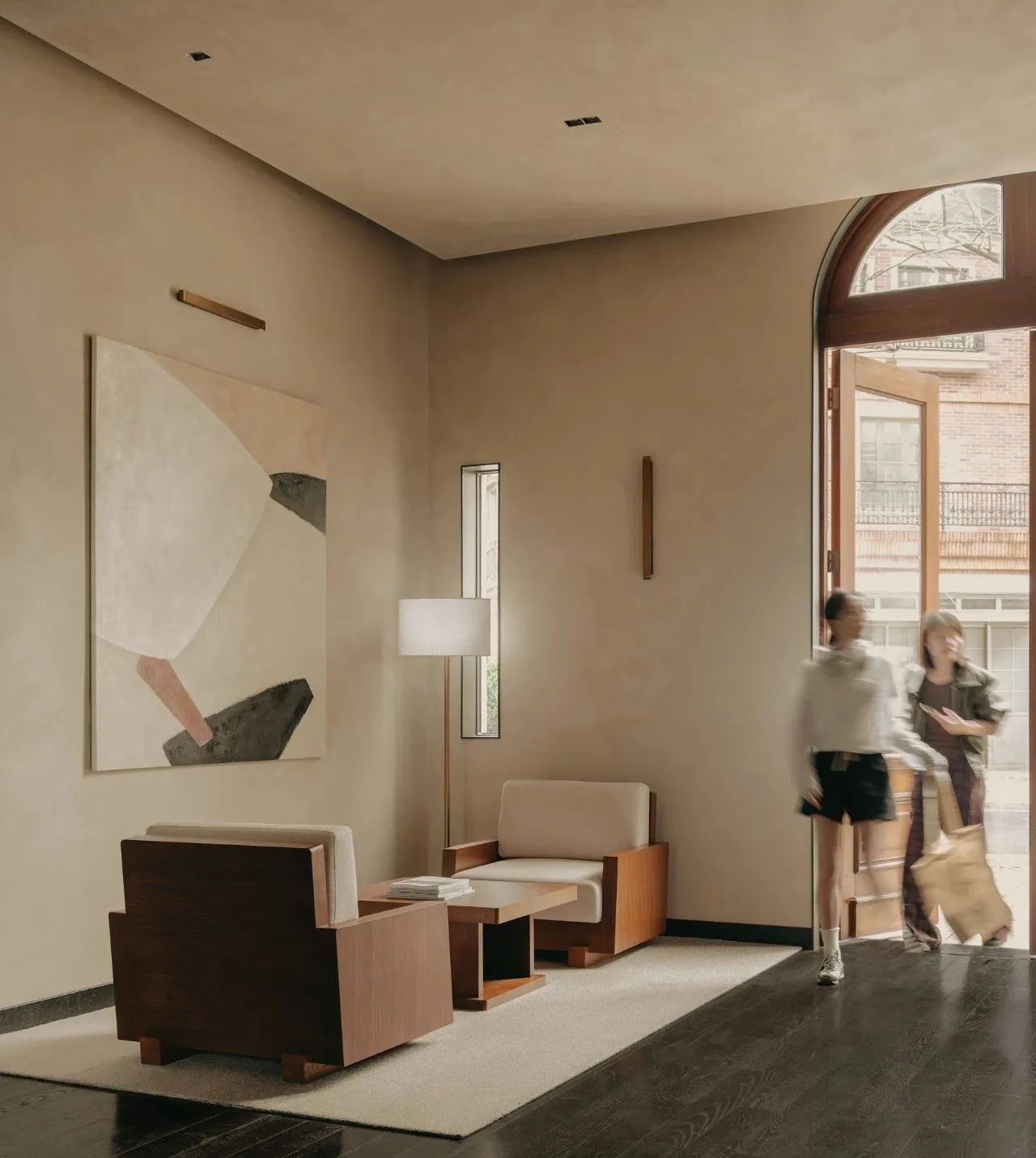 A minimalist industrial-style living room with neutral tones.