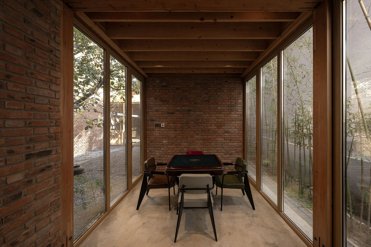 Industrial living space with brick walls, wooden furniture, and glass windows