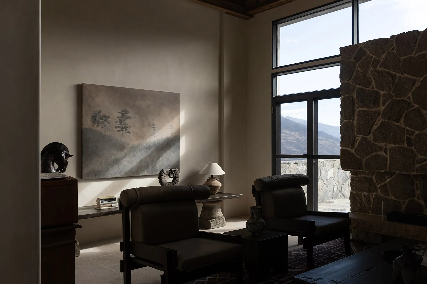 Minimalist living room with stone accents and natural light.