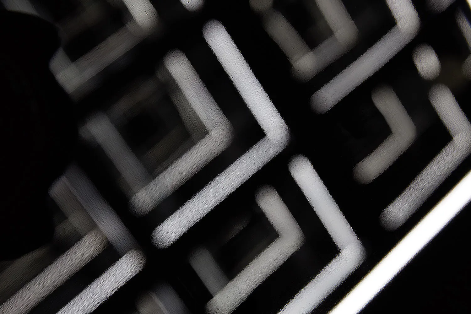 A glass floor plan showcasing an abstract geometric grid pattern.