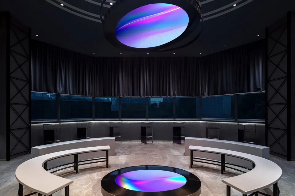 Minimalist design featuring a glass structure in a circular room