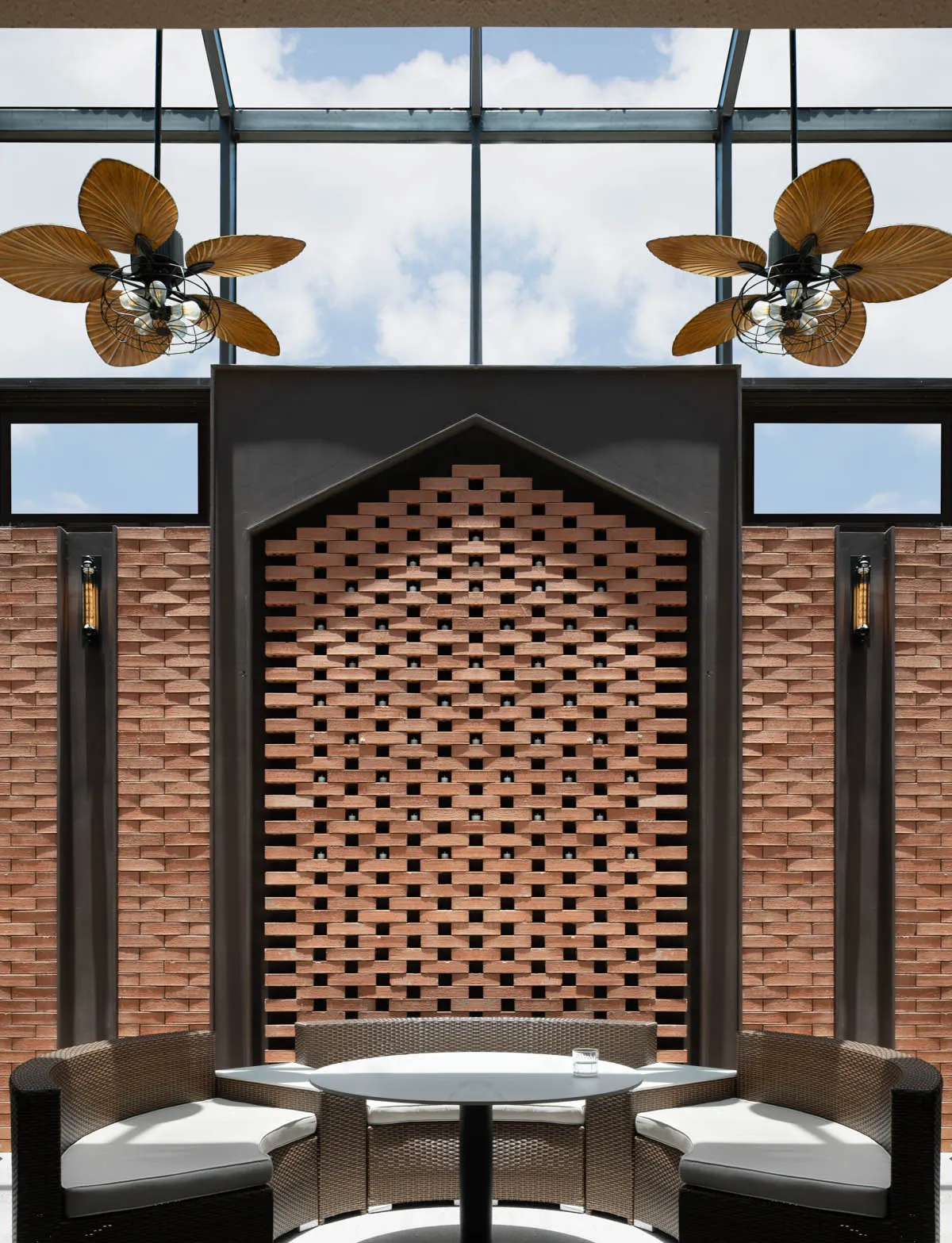 Modern coffee shop interior with a lattice wooden wall and white table and chairs.