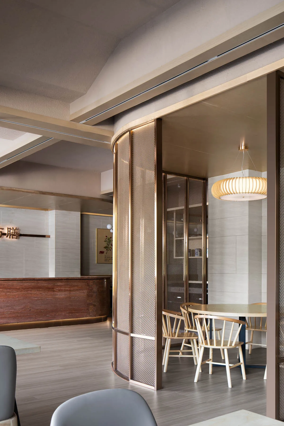 Interior of a modern coffee shop with metal and glass partitions, wooden furniture, and a contemporary design.