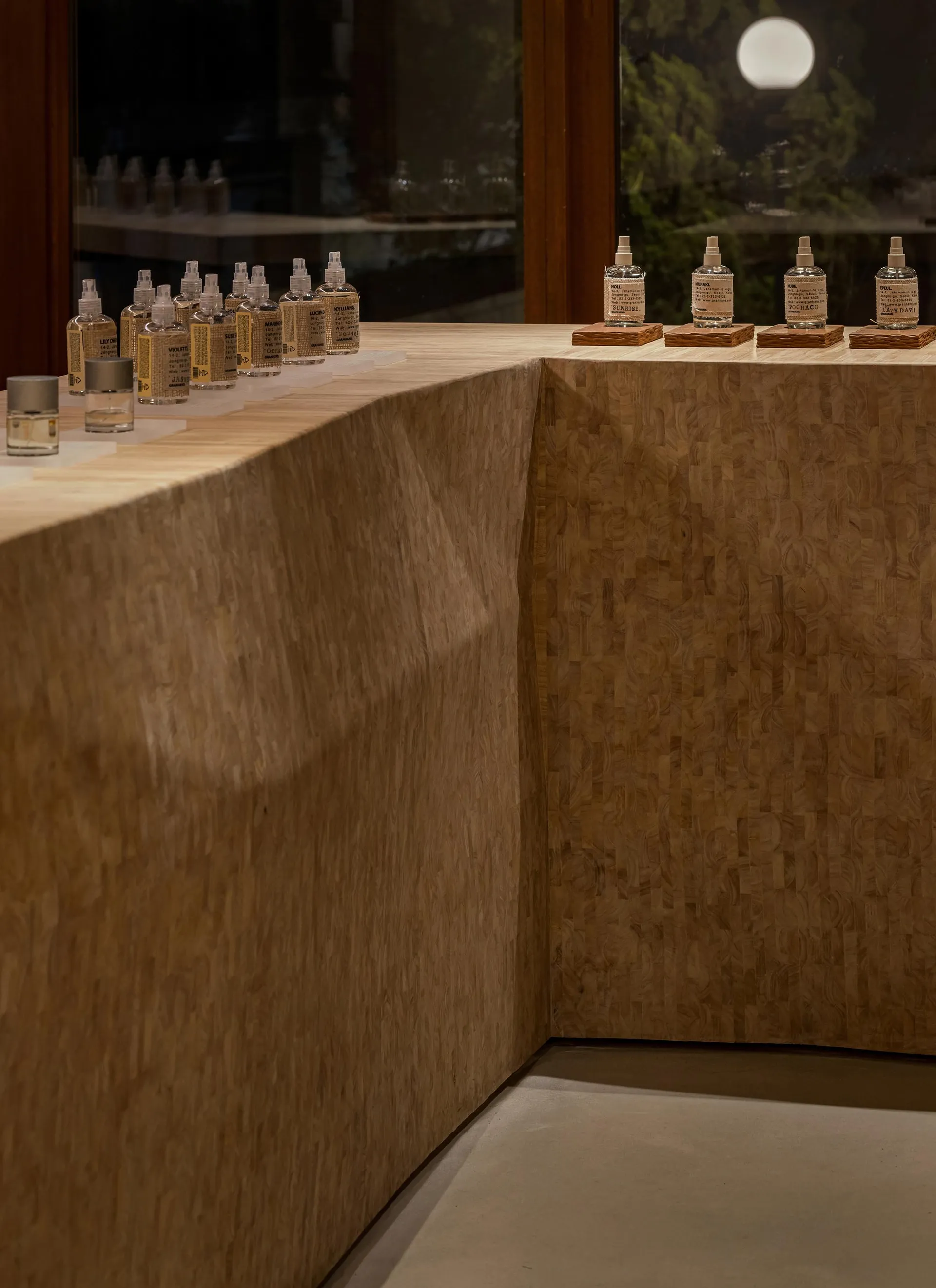 A modern retail storefront featuring a wooden display counter.