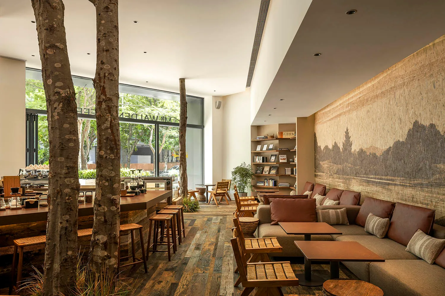 Minimalist coffee shop featuring wooden furniture and seating options.
