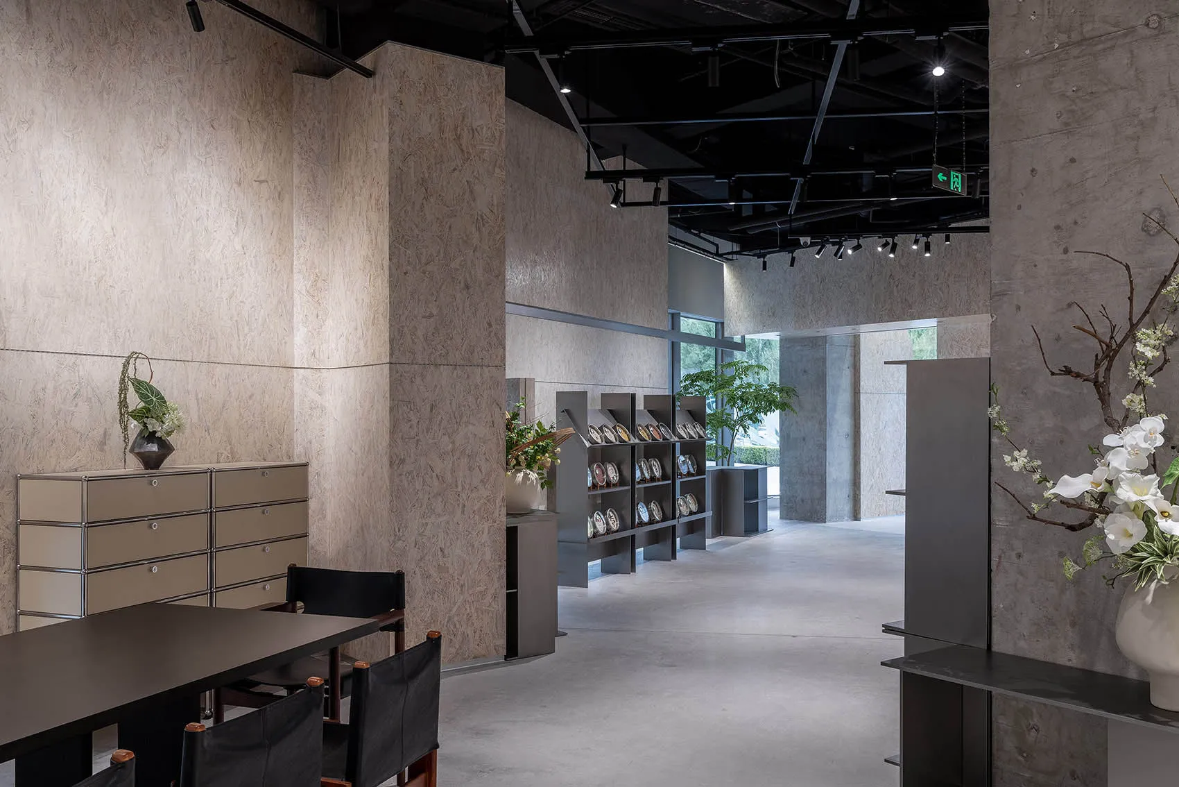 Modern showroom featuring concrete, steel, and glass materials