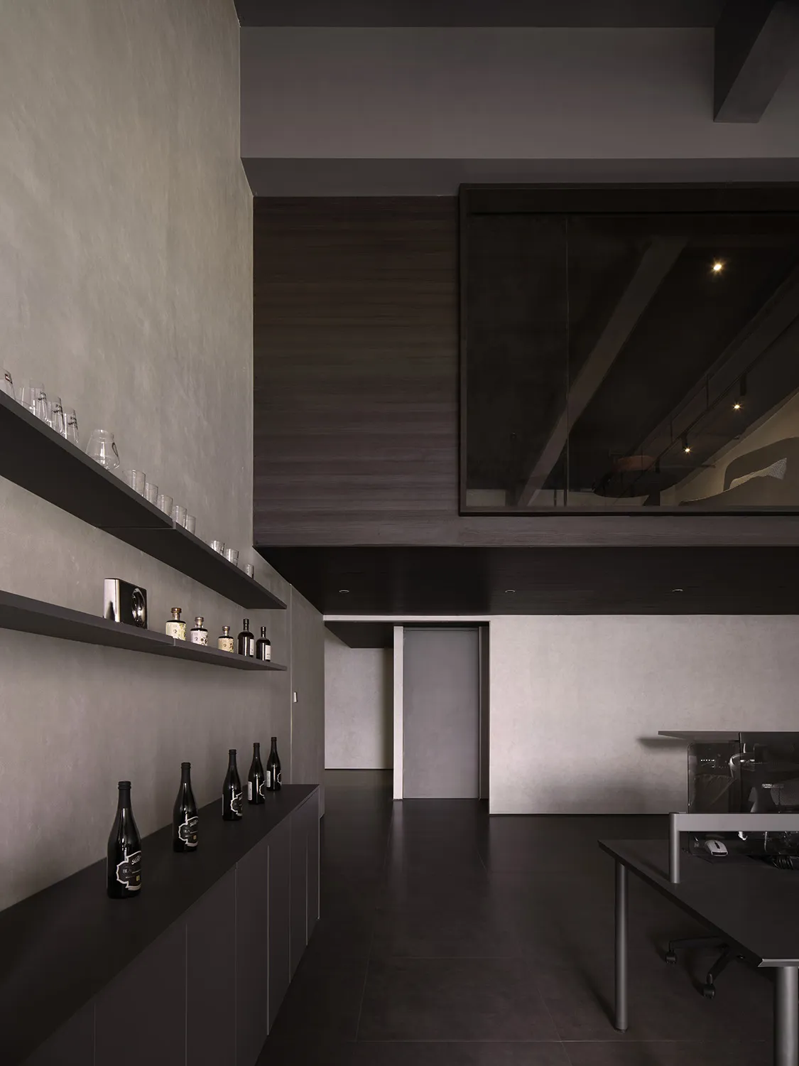 Modern industrial office space with concrete walls and metal accents.
