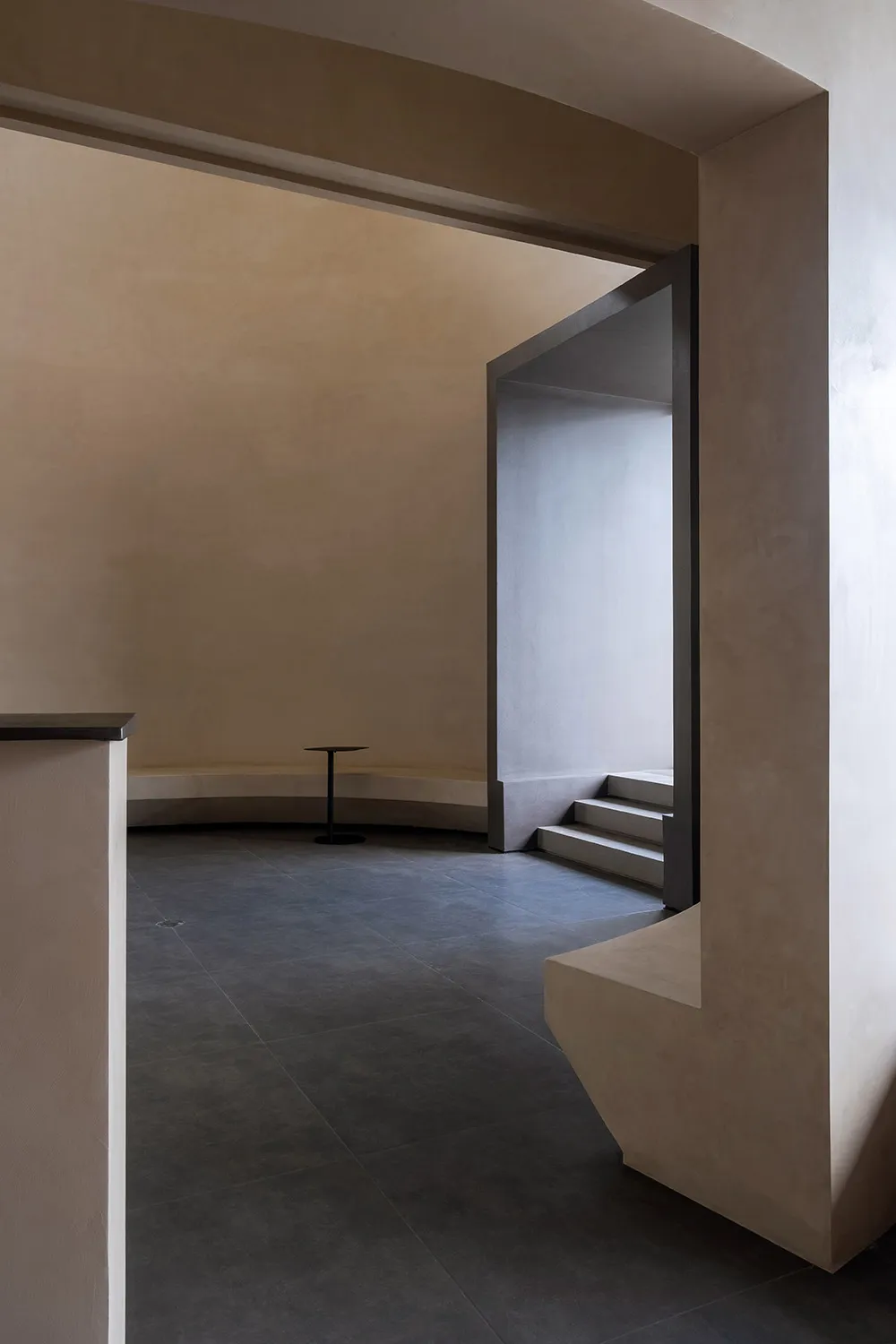 Modern interior space with concrete flooring and minimalist design elements.