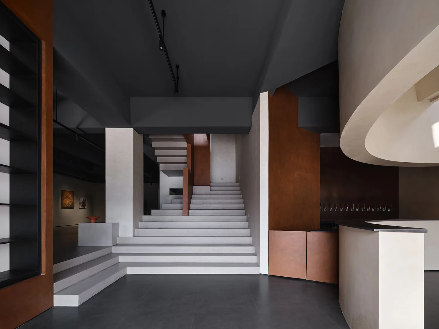 Modern lobby area with concrete stairs and walls