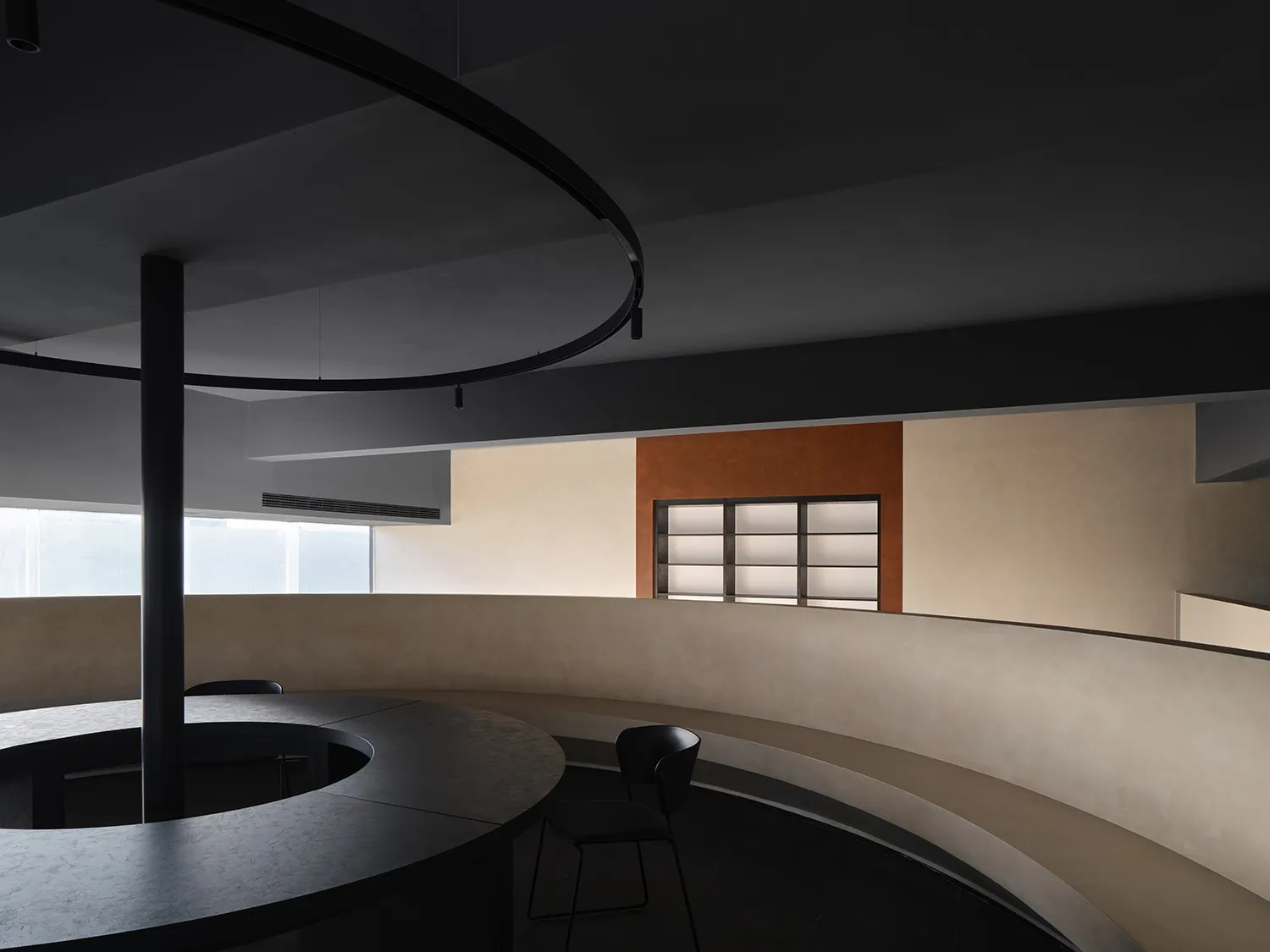 A modern office space featuring concrete and glass materials.
