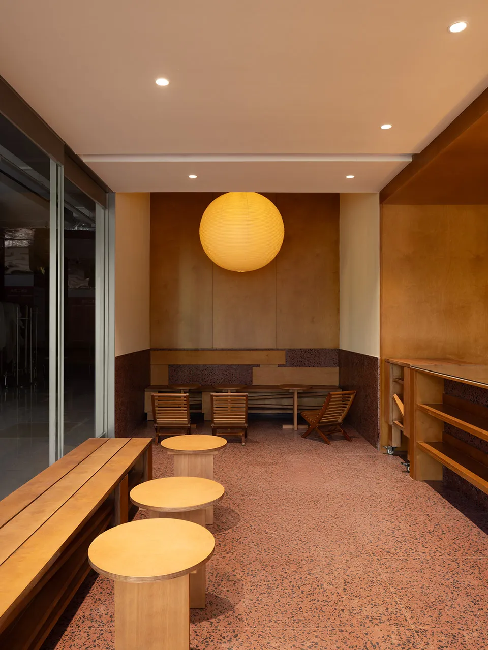 Cafe interior with wooden furniture and terrazzo flooring