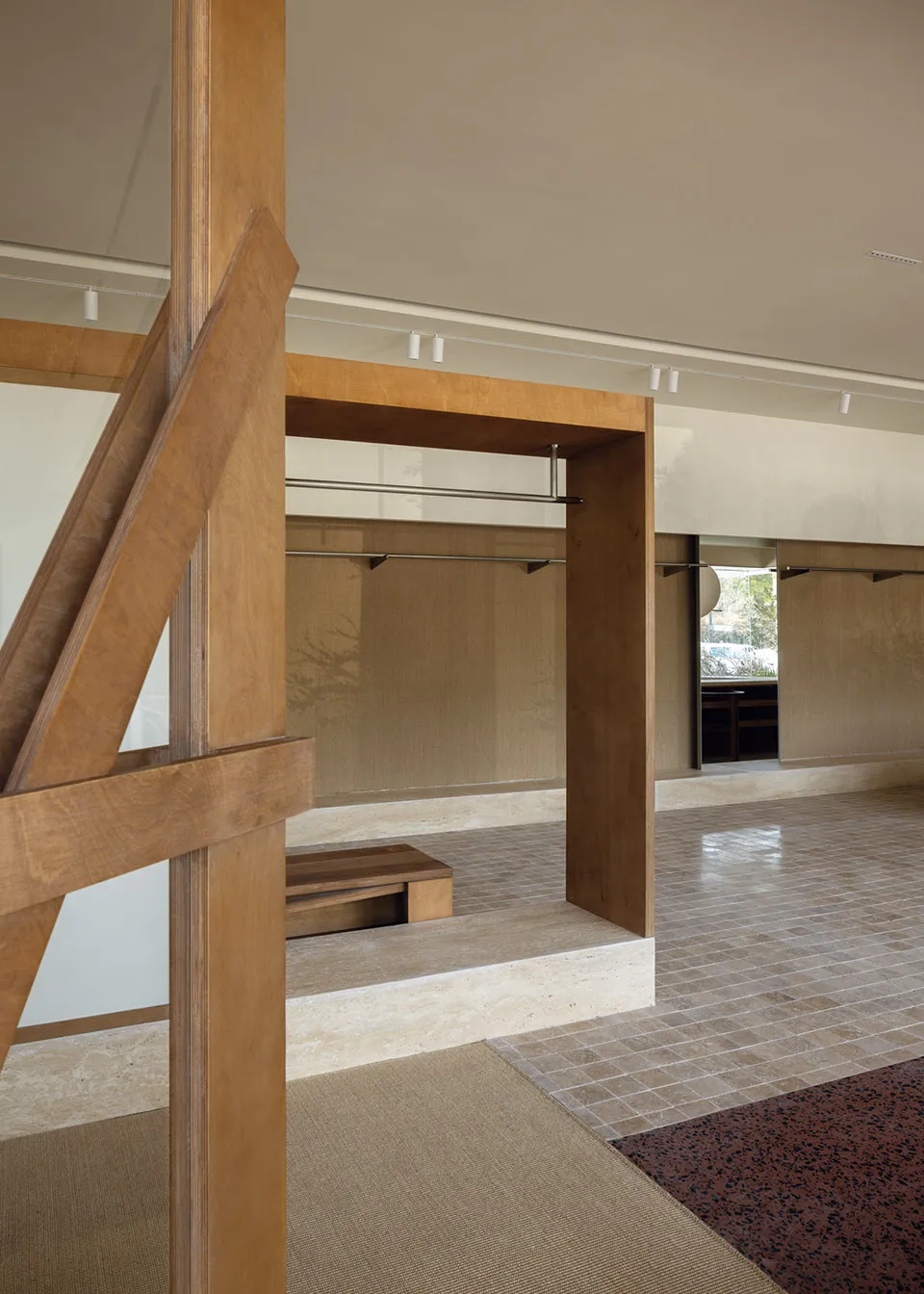 Minimalist living space with wood, tile, and carpet flooring.
