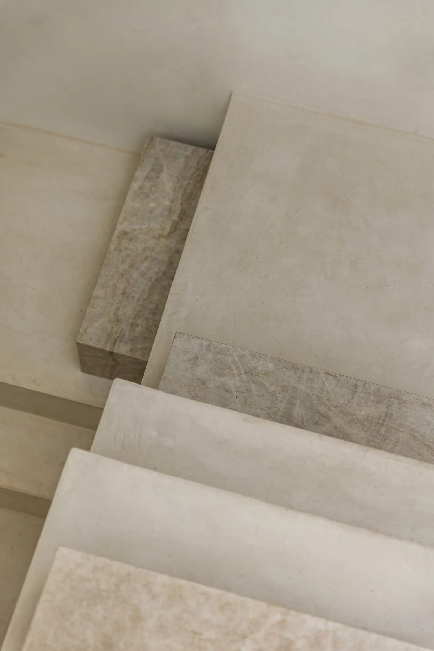 A collection of white and beige stone slabs showcasing modern interior design.