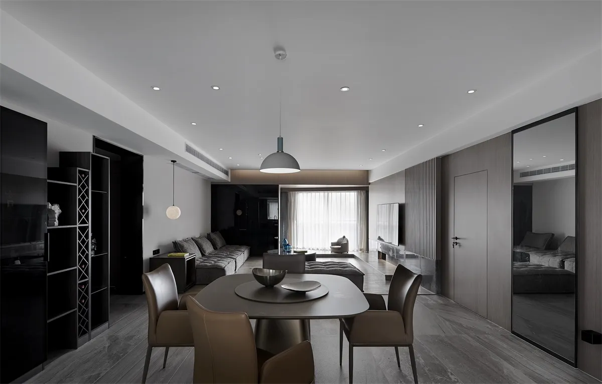 A modern living room with metallic black, white, and taupe details.