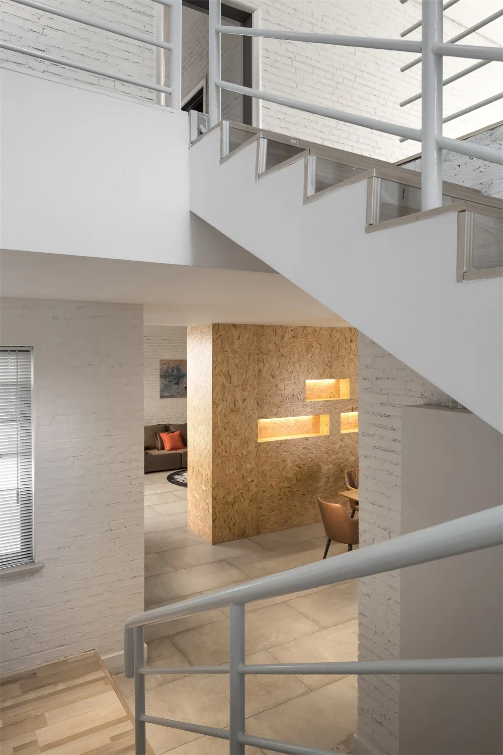 Modern and industrial-style office lounge featuring a combination of white and wooden elements.